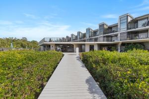 an external view of a building with a walkway at Marker 33 #2D3 in New Smyrna Beach