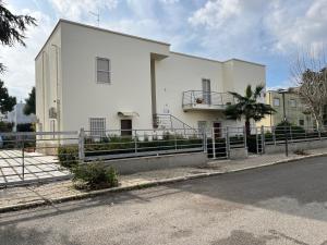 a white building on the side of a street at Afrodite Affittacamere in Metaponto