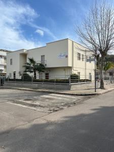 a white building on the side of a street at Afrodite Affittacamere in Metaponto