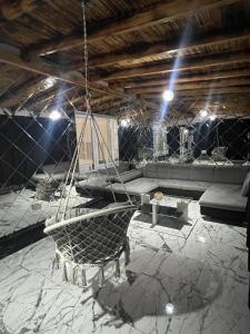 a room with a chair and a couch and lights at Casa Eva in Beclean