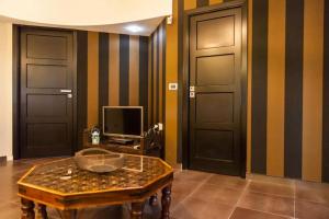 バレストラーテにあるCasa Salvoのドア2つ、テーブル1台、テレビが備わる客室です。