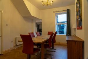 a dining room with a wooden table and chairs at The Red Door in Bangor