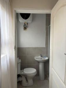 a bathroom with a toilet and a sink at Manor Rentals in Potchefstroom