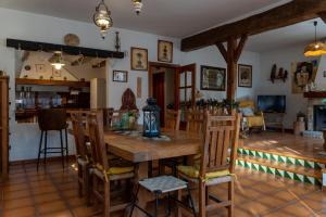 a dining room with a wooden table and chairs at Casa rural La Plana in Alcover