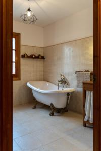 a bathroom with a white tub in a room at Casa rural La Plana in Alcover +12 photos