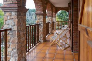 a porch with a bench and a stone wall at Casa rural La Plana in Alcover