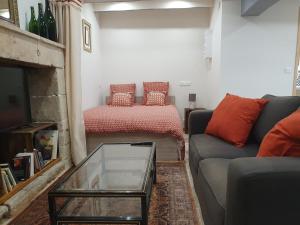 a living room with a couch and a coffee table at Maisonette, Gîte de la Mère Nini in Saint-Laon