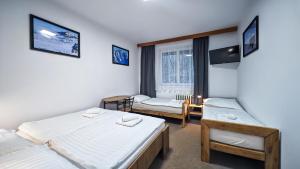 a room with two beds and a window at Penzion Vápenka in Horní Maršov +54 photos