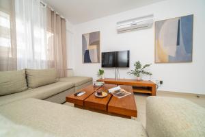 a living room with a couch and a coffee table at 2 bedroom flat in Strovolos