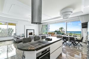 a kitchen and living room with a view of the ocean at Olymp Luxury Villa А - Beachfront Luxury Living in Kissonerga