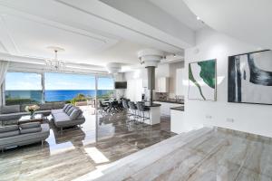 an open living room with a view of the ocean at Olymp Luxury Villa А - Beachfront Luxury Living in Kissonerga