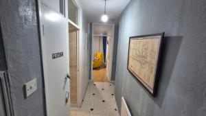 a hallway with a sign on the wall and a stairway at Totteham stadium in London +7 photos
