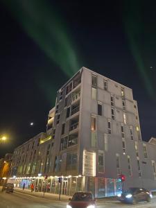 a tall building on a street at night at Tromsø Central Stay in Tromsø