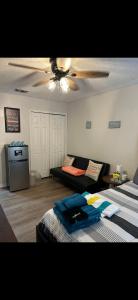 a living room with two beds and a ceiling fan at A&D Homes Peaceful Retreat in Jacksonville