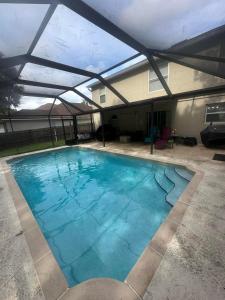 a large swimming pool with a roof at A&D Homes Peaceful Retreat in Jacksonville