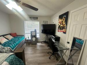 a bedroom with a bed and a flat screen tv at A&D Homes Peaceful Retreat in Jacksonville