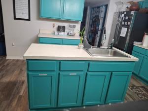 a kitchen with blue cabinets and a sink at A&D Homes Peaceful Retreat in Jacksonville +25 photos