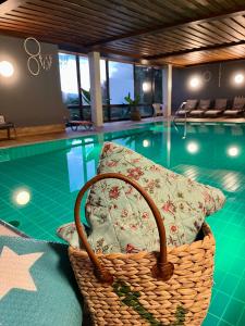a wicker basket sitting in front of a swimming pool at Goldener Hahn Ferienwohnungen Pool, Sauna & Frühstücksservice in Baiersbronn +46 photos