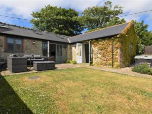 a brick house with a lawn in front of it at 2 Bed in Ventnor oc-88857 in Niton