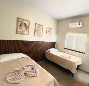 a hospital room with two beds and a window at Pousada Vereda Encantada in São Félix do Tocantins