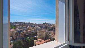 a view of a city from a window at Hotel Sicilia in Enna