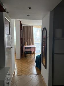 a living room with a table and a window at Zakątek in Warsaw