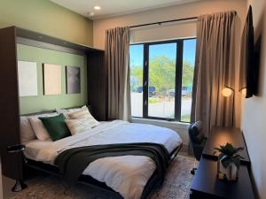 a bedroom with a bed and a large window at New Upscale & Modern Heated Pool Home in Walkable Downtown! in Sarasota +89 photos