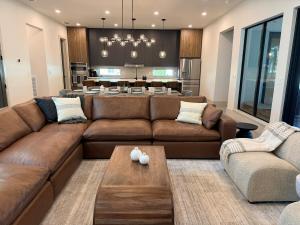 a living room with a couch and a table at New Upscale & Modern Heated Pool Home in Walkable Downtown! in Sarasota