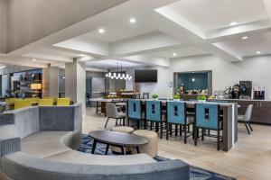 a rendering of a lobby with tables and chairs at Best Western Plus Elgin - Chicago in West Dundee
