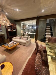 a living room with a couch and a table and chairs at The City Hotel London in London