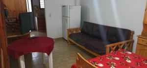 a living room with a couch and a table at Duplex 137 Gesell in Villa Gesell