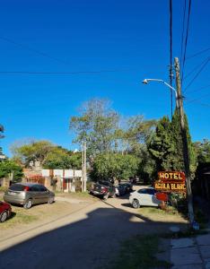 a sign for a motel in a parking lot at Duplex 137 Gesell in Villa Gesell +1 photo
