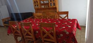 a dining room table and chairs with a red table cloth at Duplex 137 Gesell in Villa Gesell