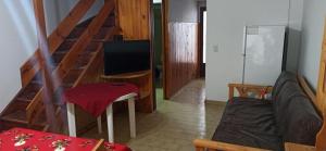 a living room with a couch and a television at Duplex 137 Gesell in Villa Gesell