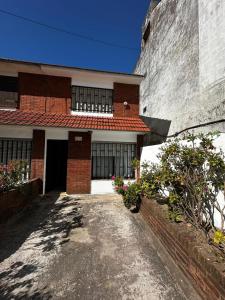 a brick building with a driveway in front of it at Duplex 137 Gesell in Villa Gesell