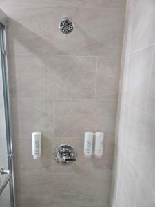 a bathroom with a shower with a shower at Sleep Inn in Brooklyn