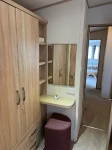 a dressing room with a vanity and a mirror at Joy & Mick's Happy Place in Morecambe +42 photos