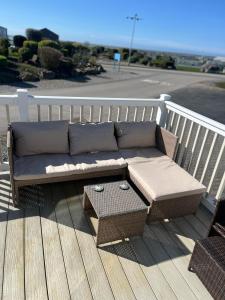 a couch sitting on top of a deck at Joy & Mick's Happy Place in Morecambe