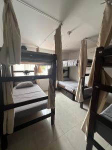 a room with three bunk beds in a room at Casa Epifania Miraflores hostel in Cali