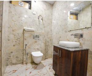 a bathroom with a sink and a toilet in it at Hotel Villa Getaway in New Delhi +9 photos