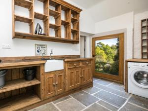 a kitchen with a sink and a washing machine at 4 Bed in Buxton oc-57687 in Millers Dale +22 photos
