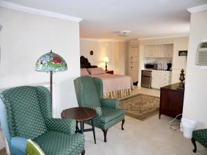 a bedroom with a bed and a table and chairs at Turkey Hill Inn in Summit