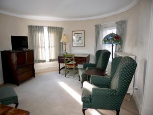 a living room with chairs and a table and a desk at Turkey Hill Inn in Summit