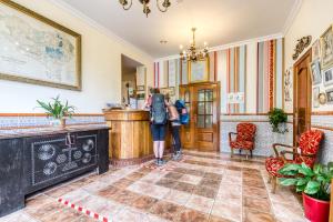 two people standing in a hallway in a building at Hotel Leku Eder in San Sebastián