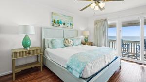 a bedroom with a bed with a view of the ocean at Blue Nine 2 in Panama City Beach