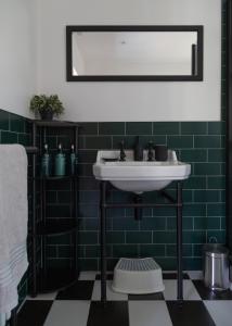 a bathroom with a sink and a green tiled wall at Stanton Lodge Cottage - 2 bedrooms - sleeps 5 in Curbar +47 photos