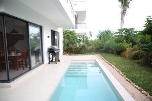 a swimming pool in the backyard of a house at Bustani villa in Zanzibar City +9 photos