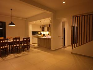 a kitchen and dining room with a table and chairs at Bustani villa in Zanzibar City