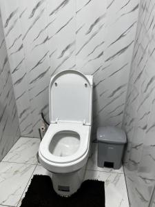 a bathroom with a toilet and a trash can at Hotel Zukhritdin in Bukhara +19 photos