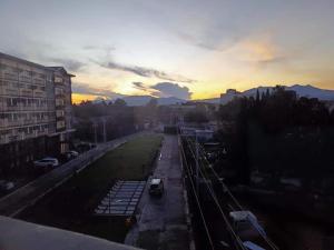 a view of a city with a sunset in the background at Rye Lees Place in Bacolod